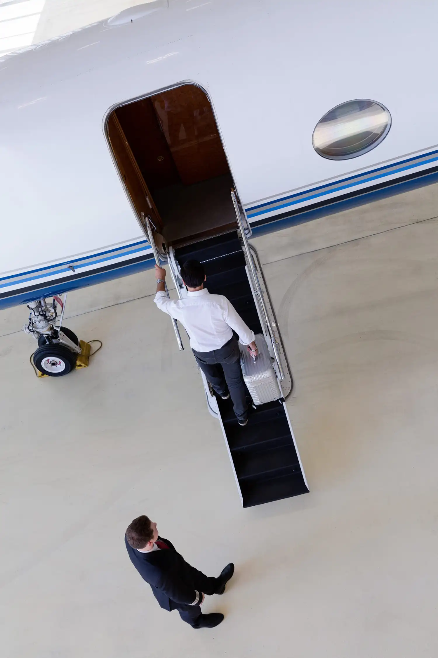 A businessman stepping into a business jet.