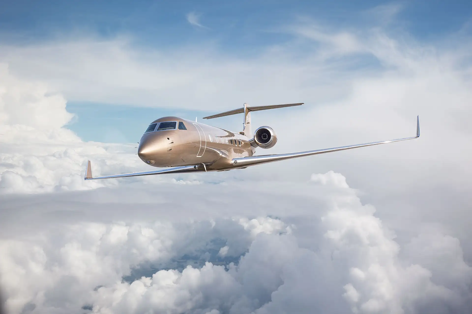 A Gufstream G550 mid flight sky high in the clouds.