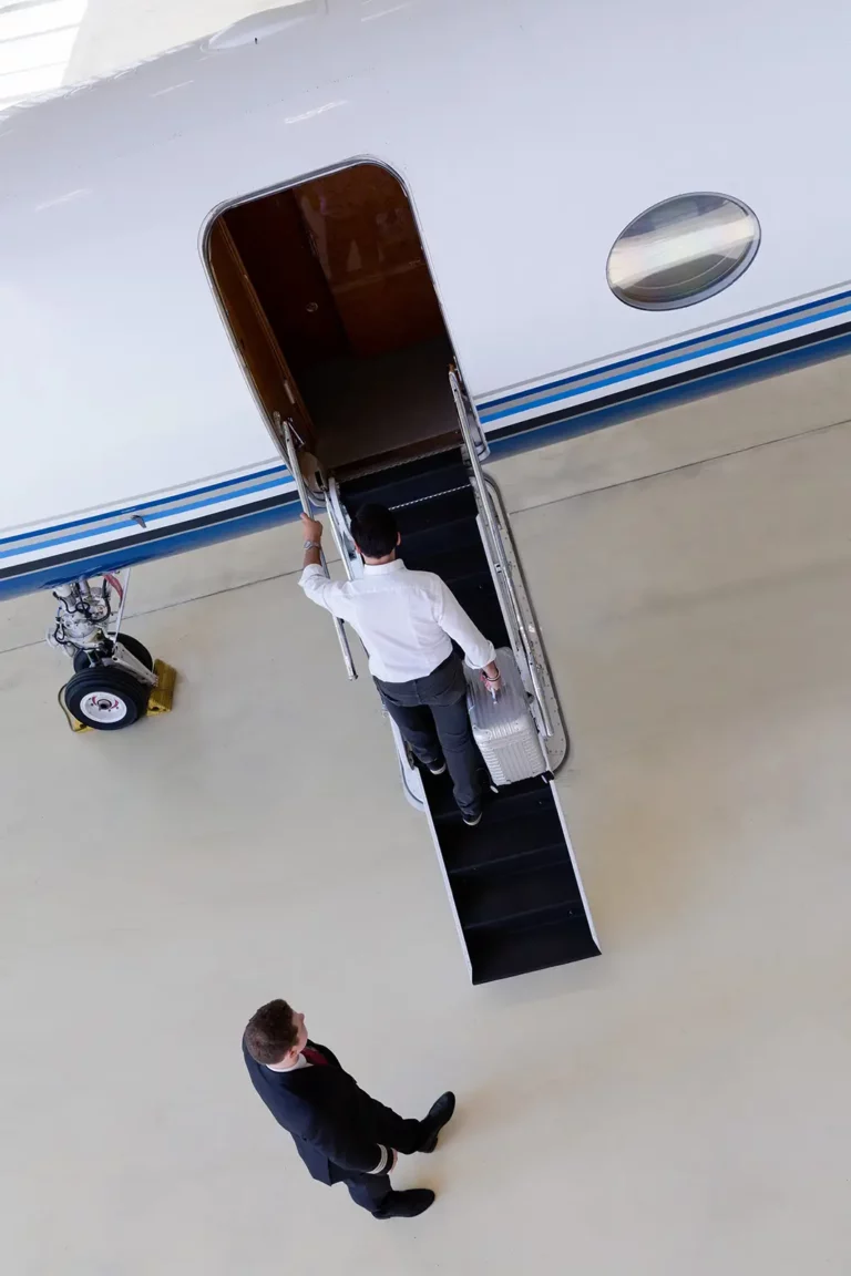 A businessman stepping into a business jet.