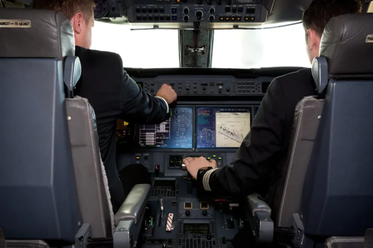 A flight crew inside the cockpit ready for takeoff.
