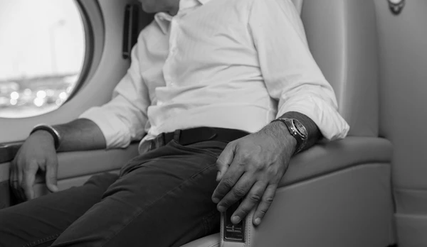 A businessman travelling comfortable with one of Avcon Jet's business jets.